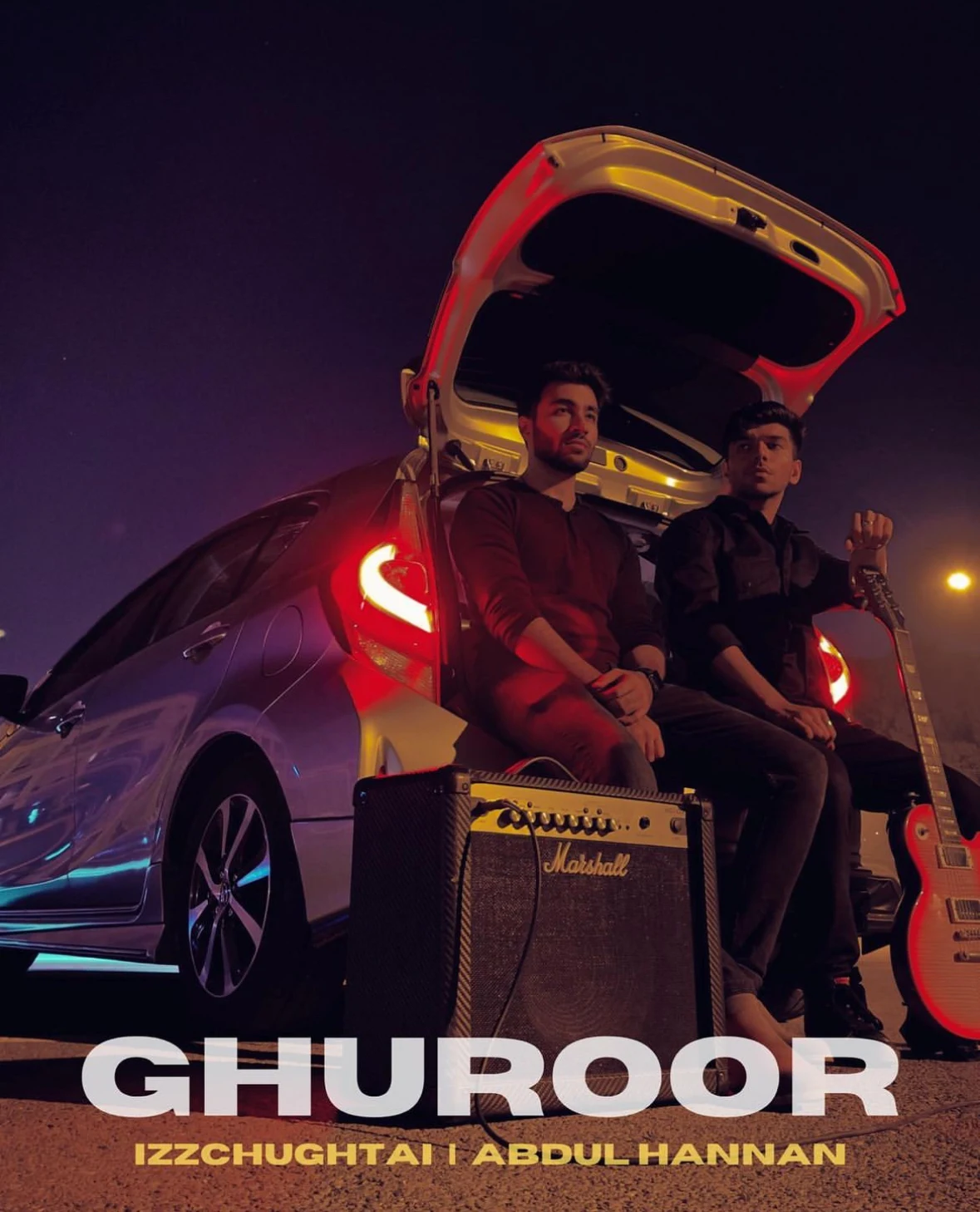 Ghuroor artwork with two musicians beside a car and guitar amplifier at night