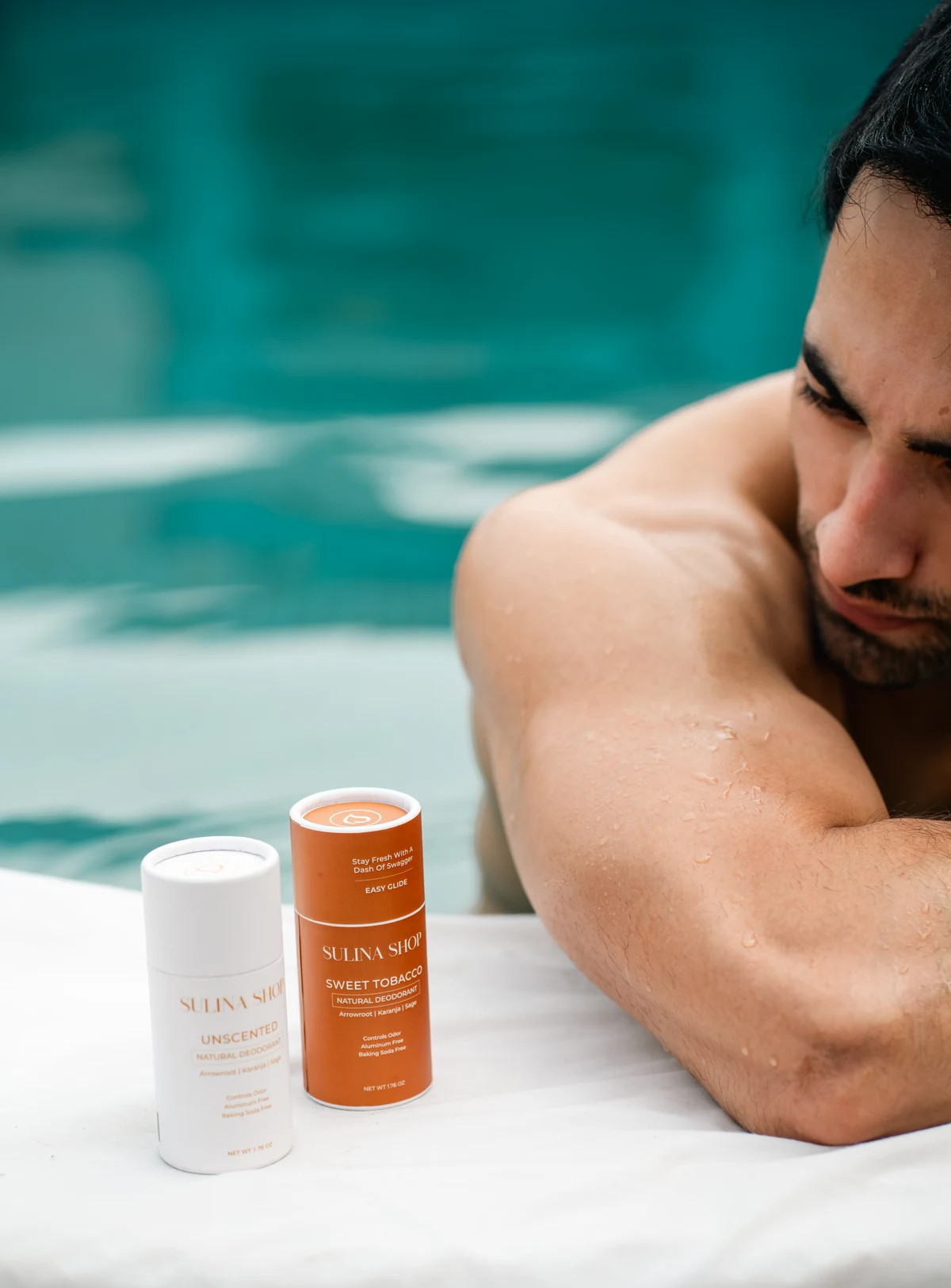 Sulina Shop deodorants beside a model at the edge of a pool